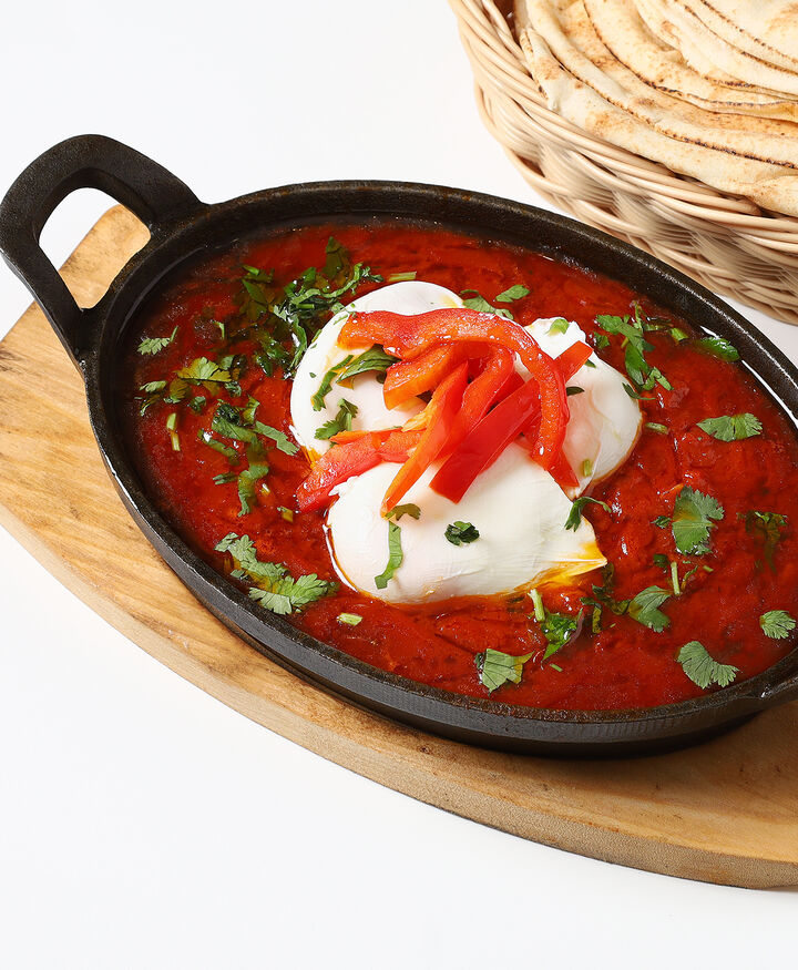 Shakshuka with sujuk: poached eggs in rich tomato sauce