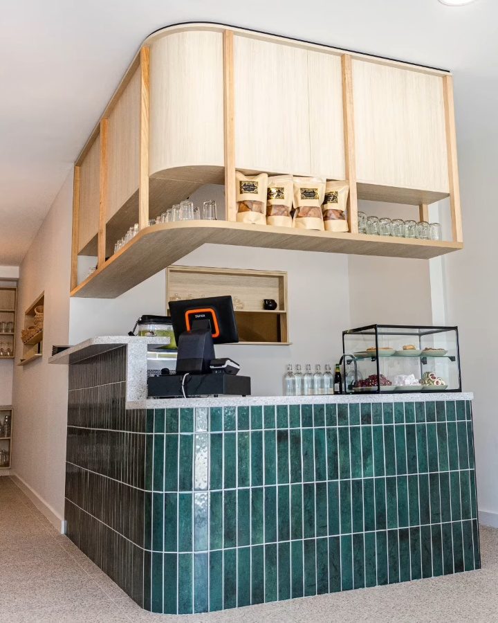 The green-tiled front counter under a curved timber canopy in Five Dock