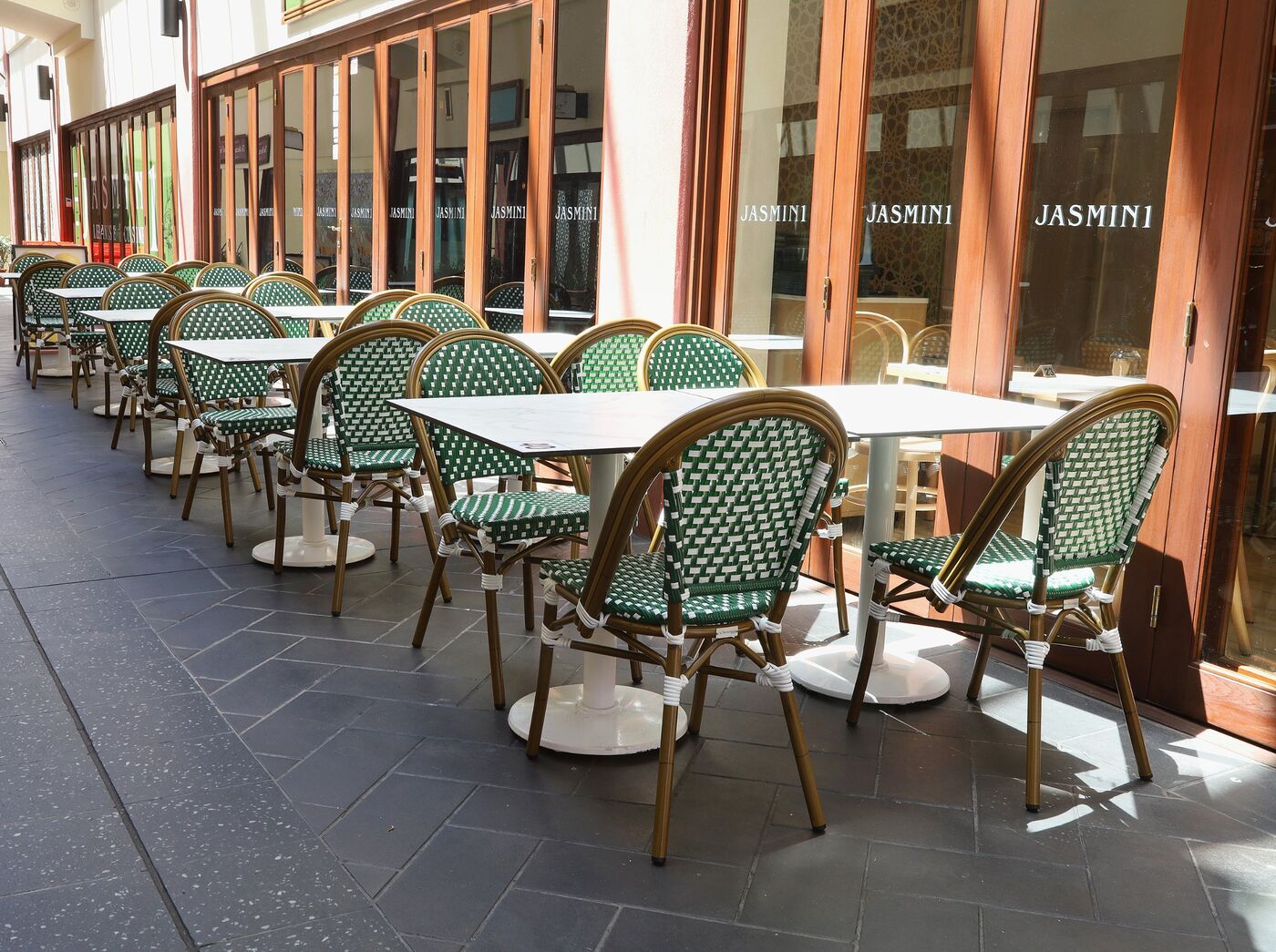 Green bistro chairs and tables outside Jasmin 1 in the Italian Forum, Leichhardt